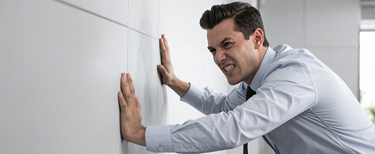 business person pushing a wall